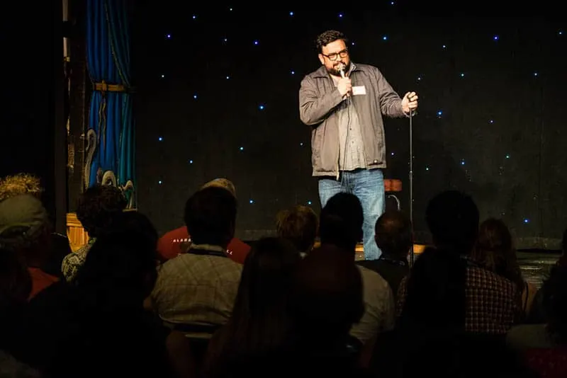 stand up comedian performing in front of crowd