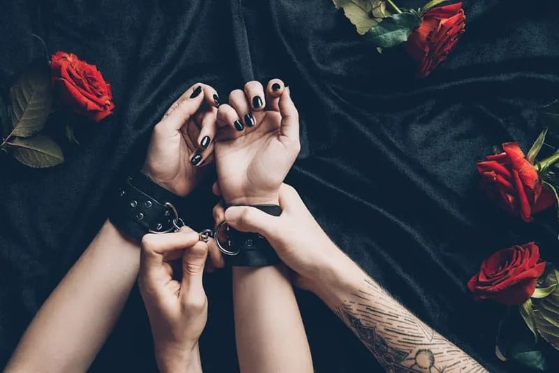 tied woman hands with handcuffs