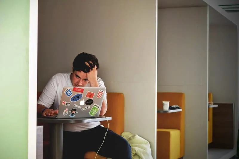 upset man typing on his laptop