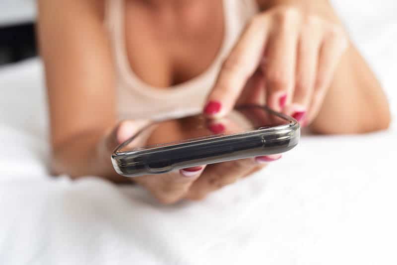 woman typing on the phone