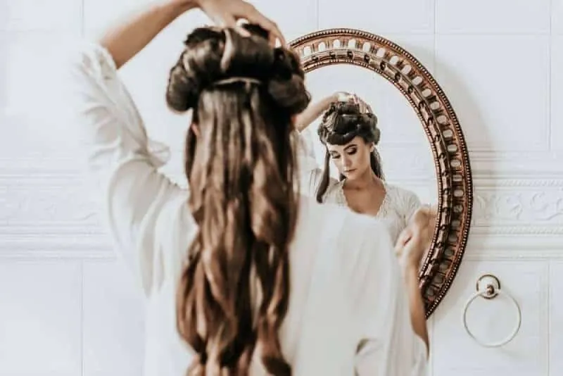 woman wearing white dress infornt of the mirror