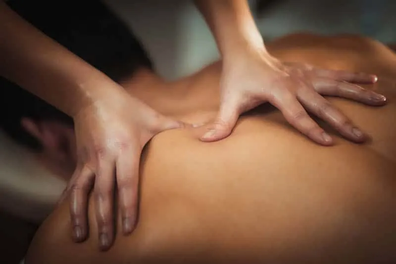 woman's hands massaging a man