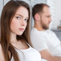 serious woman looking away from man