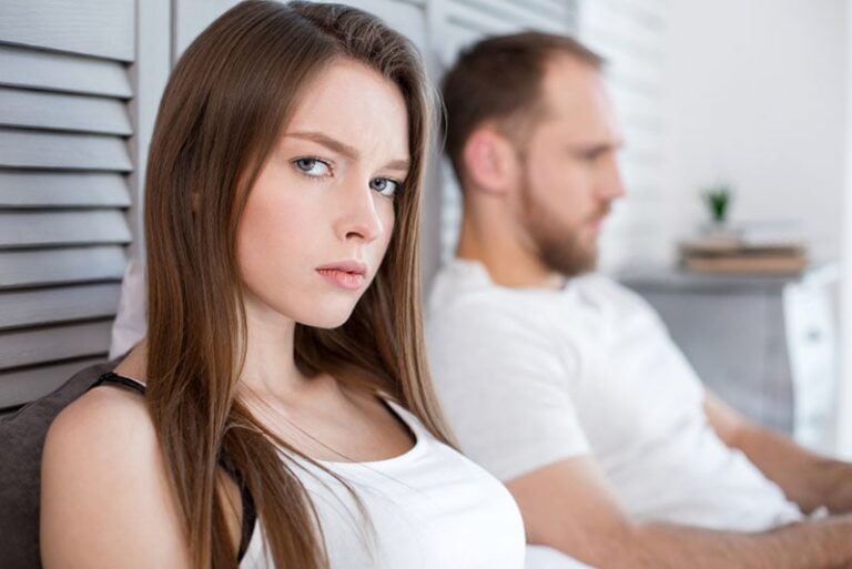 serious woman looking away from man