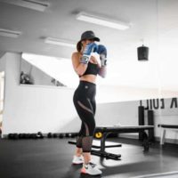 sport woman wearing boxer gloves in gym