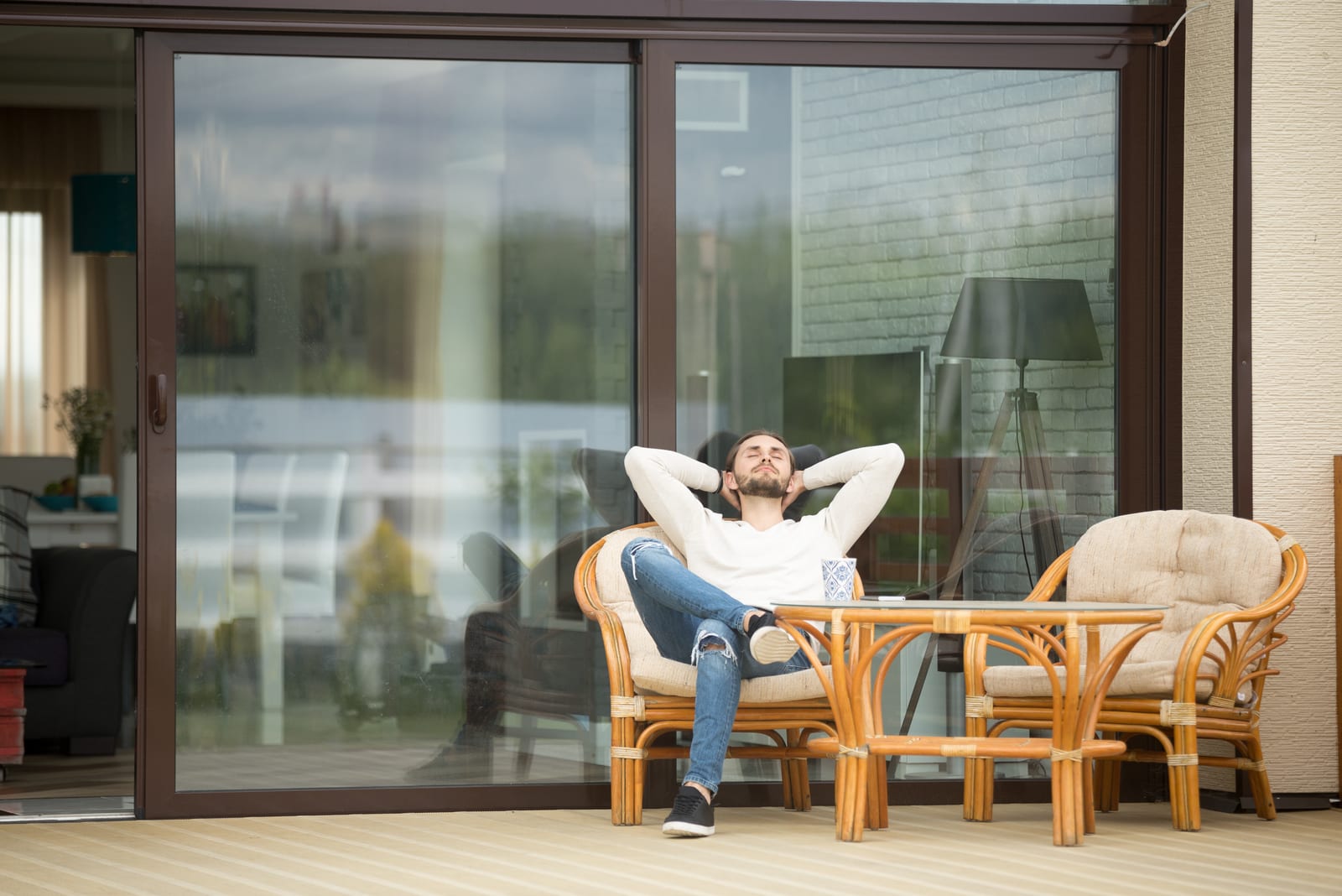 a man resting on a terrace in an armchair