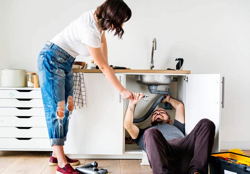 man fixing sink at home