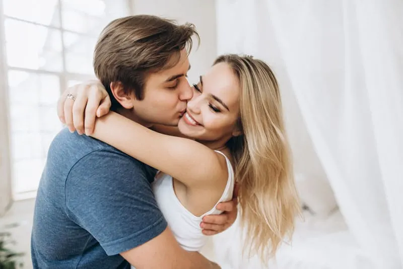 man kissing a woman