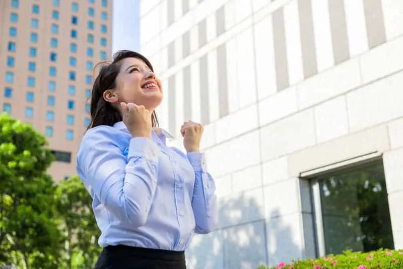 smiling business woman standing outside