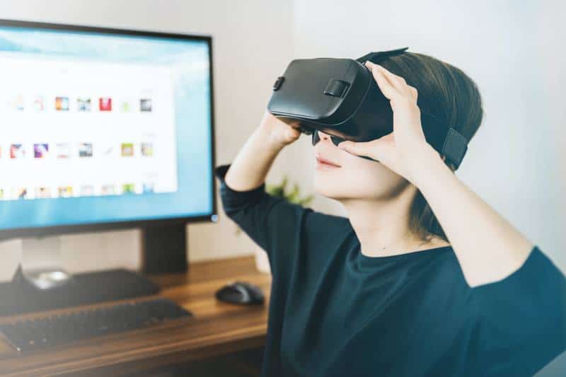woman using black VR headset