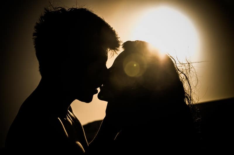 young couple kissing in dark