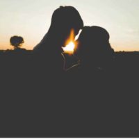 silhouette of couple standing in front of each other