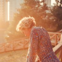 sad woman standing in the park