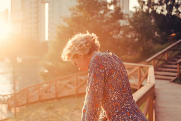 sad woman standing in the park