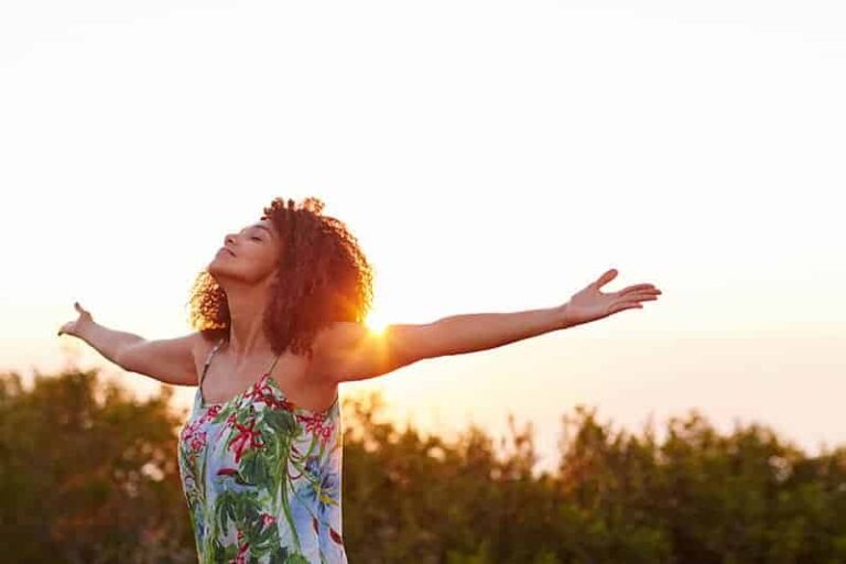 happy woman raising her hands to sky