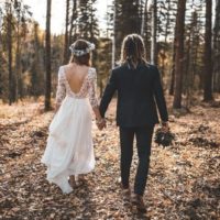 a man and a woman hold hands and walk