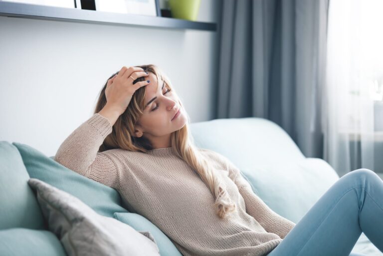 woman sitting on sofa at home