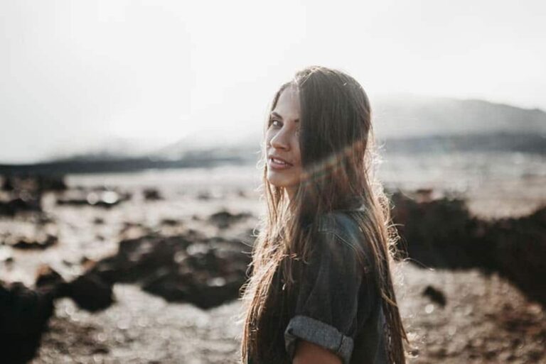 a woman standing by the sea