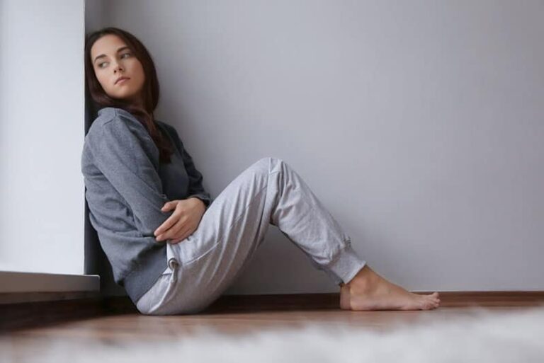 worried woman sitting on the floor