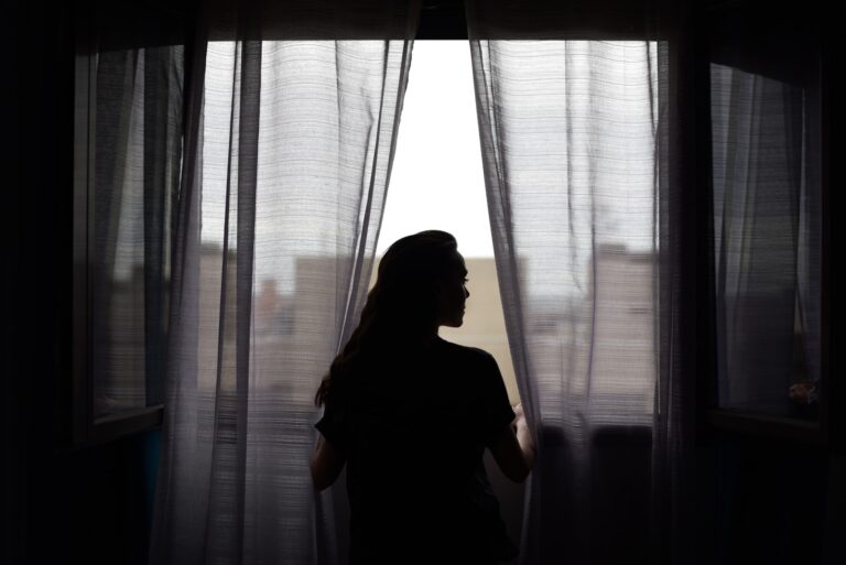 sad woman standing in the dark