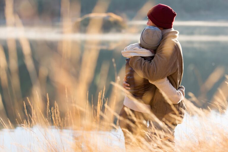 couple hugging in front of lake