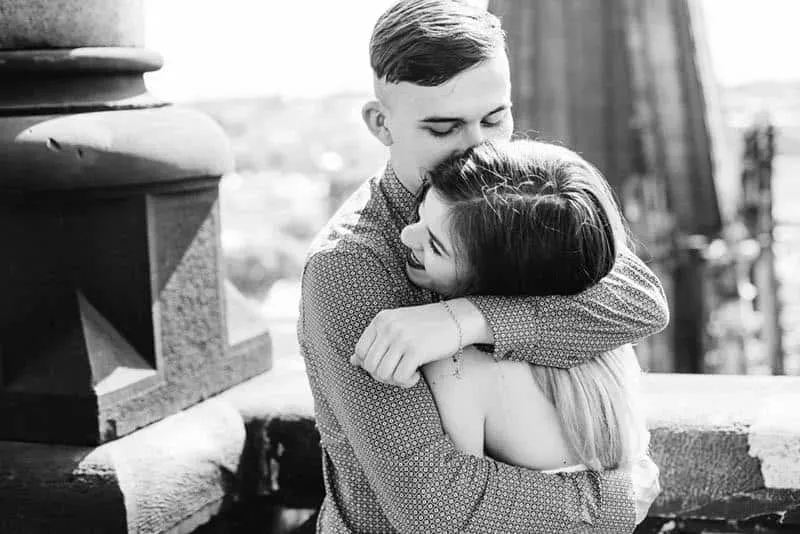 black and white photo of couple hugging outside