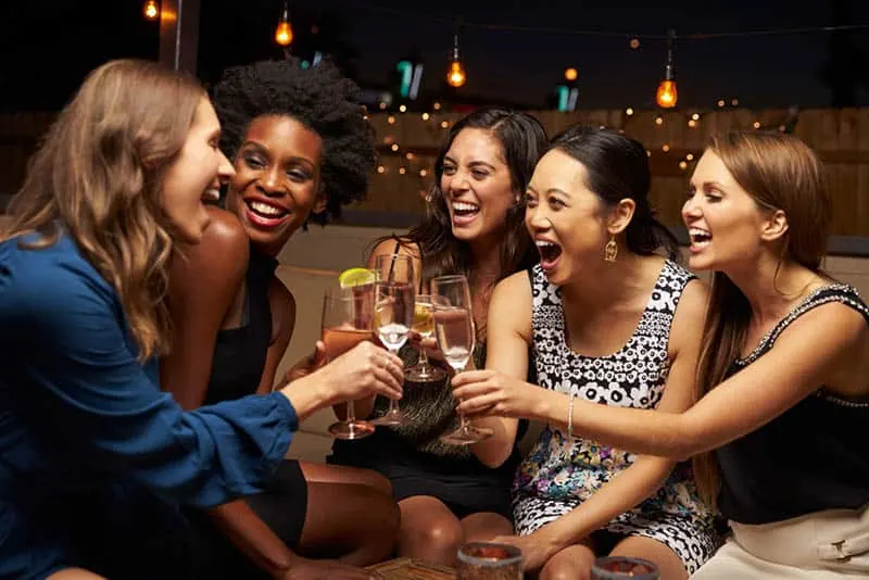 female friends cheering drinks