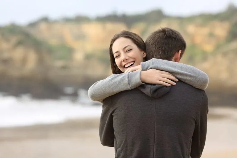 Happy couple of teens hugging