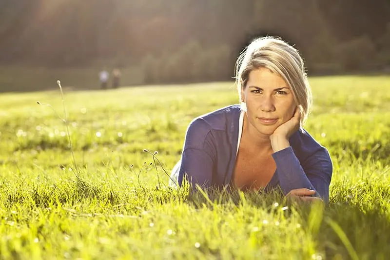 Portrait Of A Blond Woman Relaxing At The Park