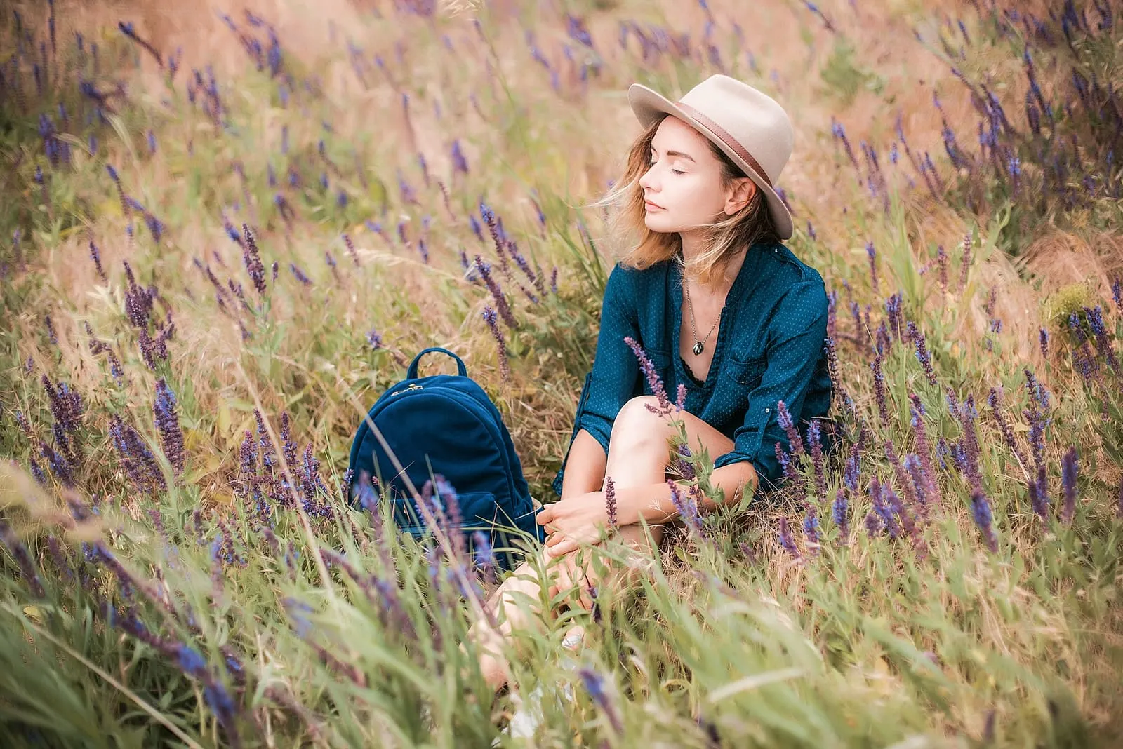 woman sitting in a grass on sunny day
