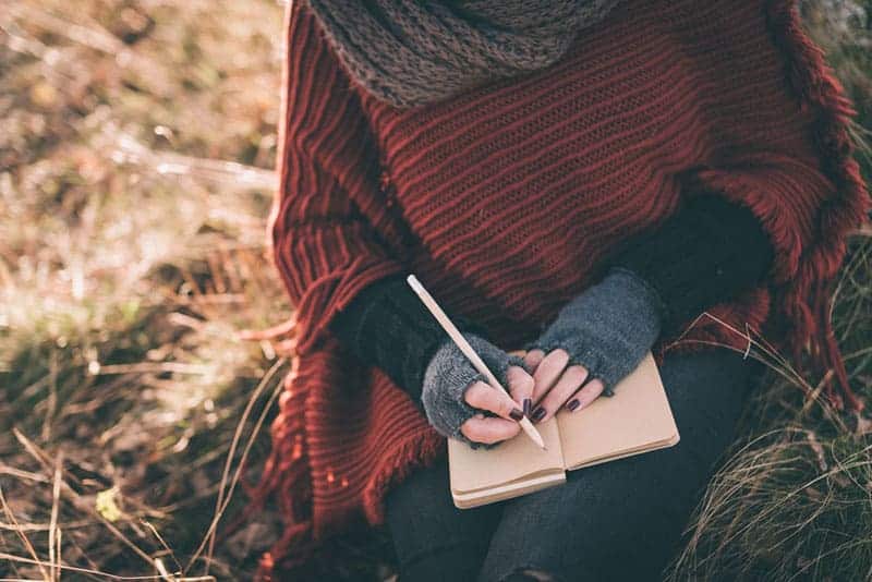 woman writing on notebook