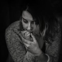 depressed woman biting nails