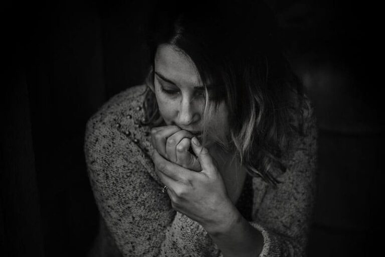 depressed woman biting nails