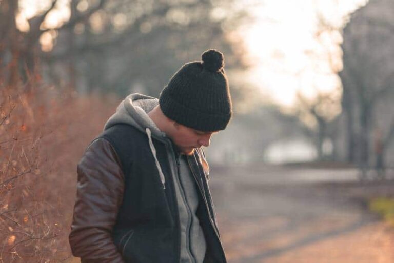 young man looking down on street
