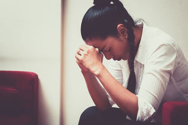 stressed young woman sitting alone