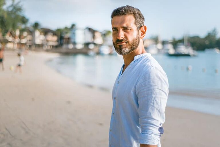 portrait of man wearing shirt at the beach