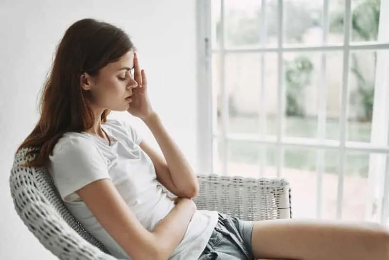 A worried woman holding her head