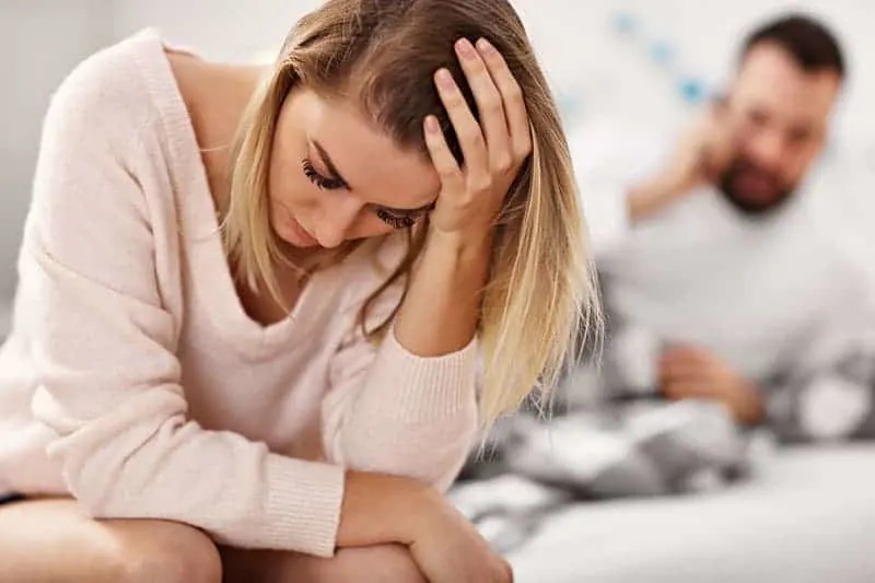 Adult attractive couple in bed having problem
