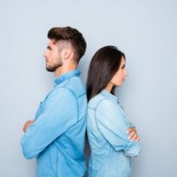 woman and man standing back to back