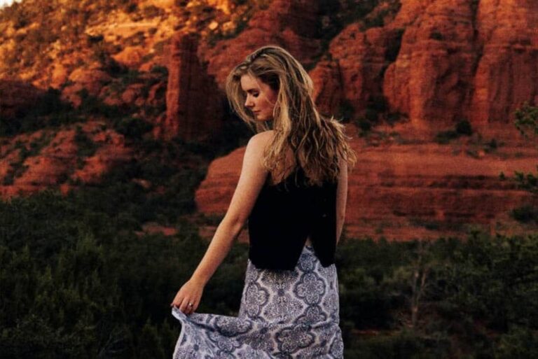 the woman stands with her back turned