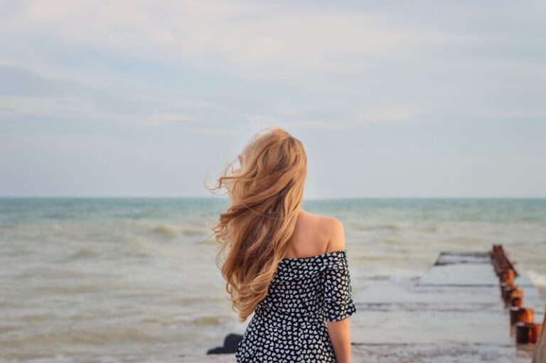 attractive woman standing on the pier