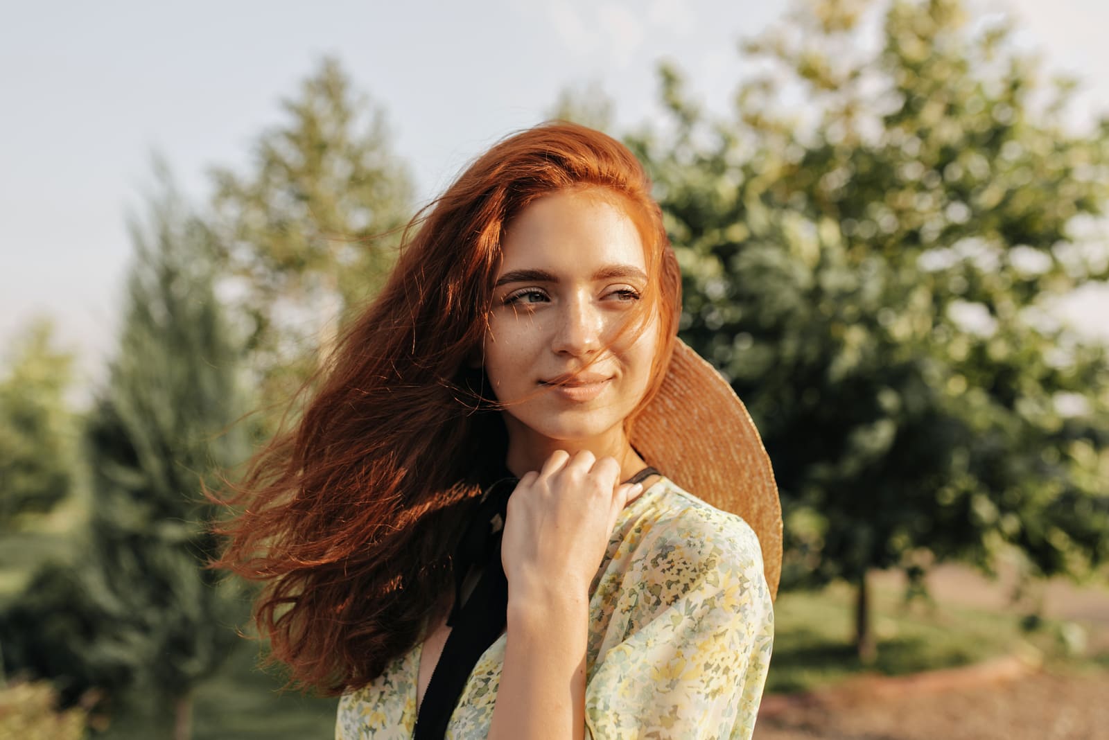 Red haired young woman with cute freckles and brown eyes