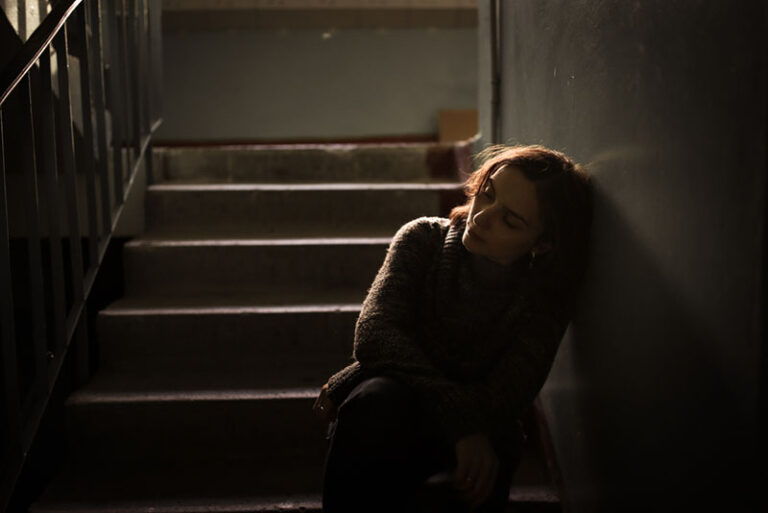 sad woman sitting on the stairs