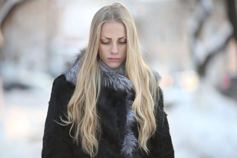 a woman with long blonde hair in a black clear set with her head down
