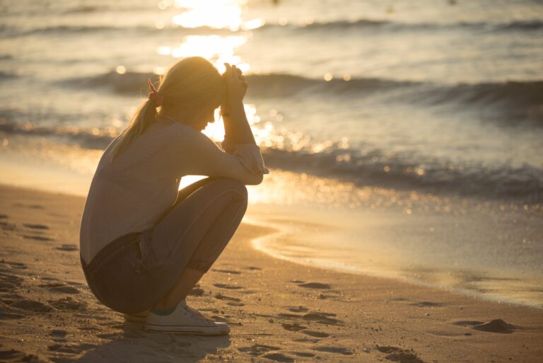 worried woman sitting on the beach