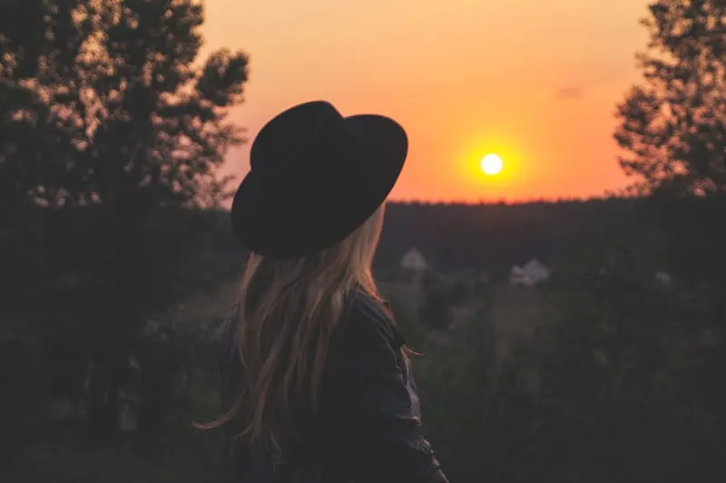 young girl with hat in sunset