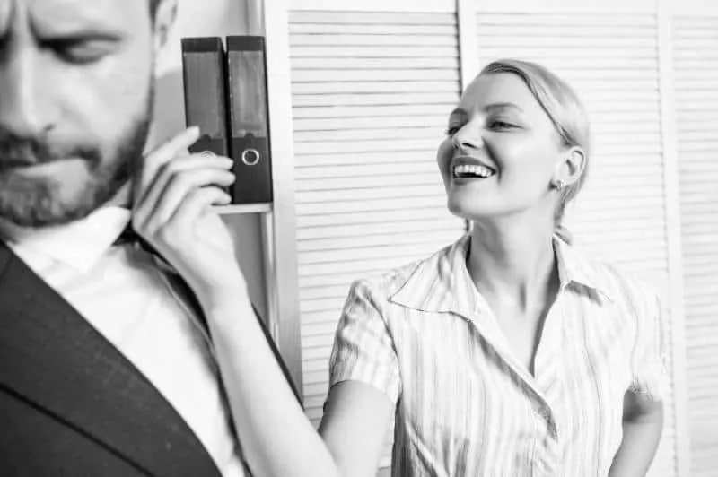 black and white photo of smiling woman teasing man