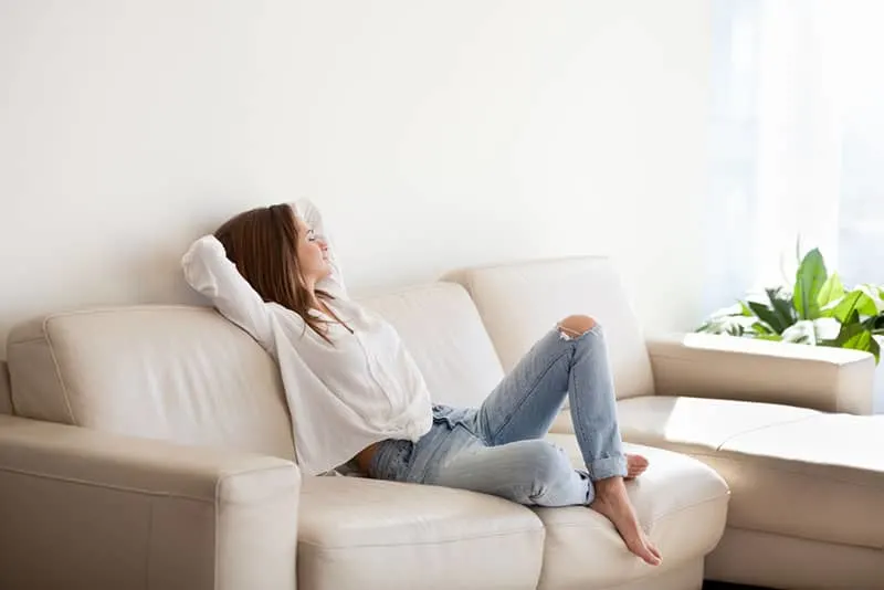 calm woman sitting on sofa