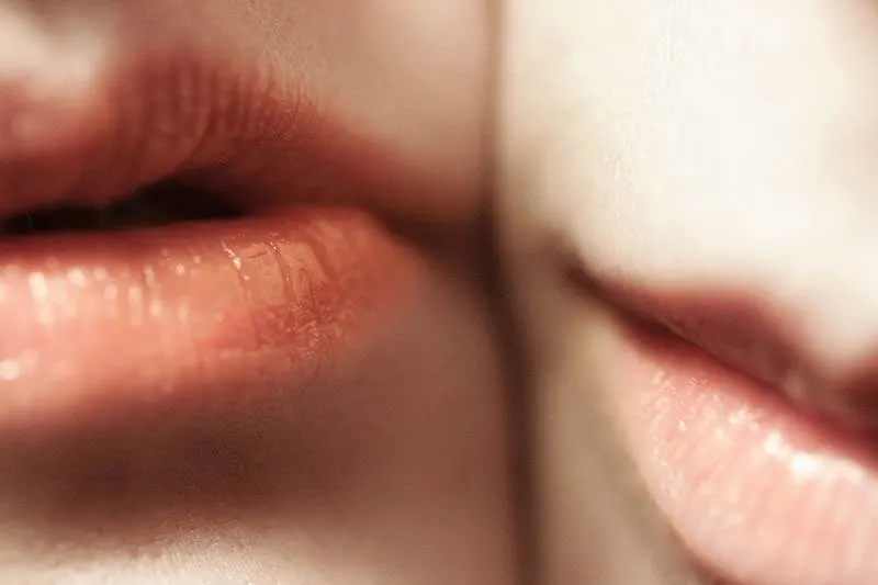 closeup photo of two persons lips