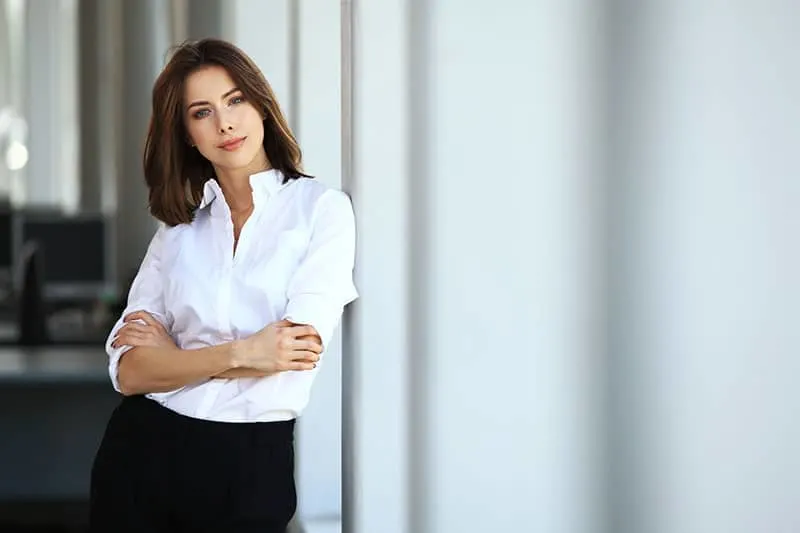 confident woman posing in white shirt